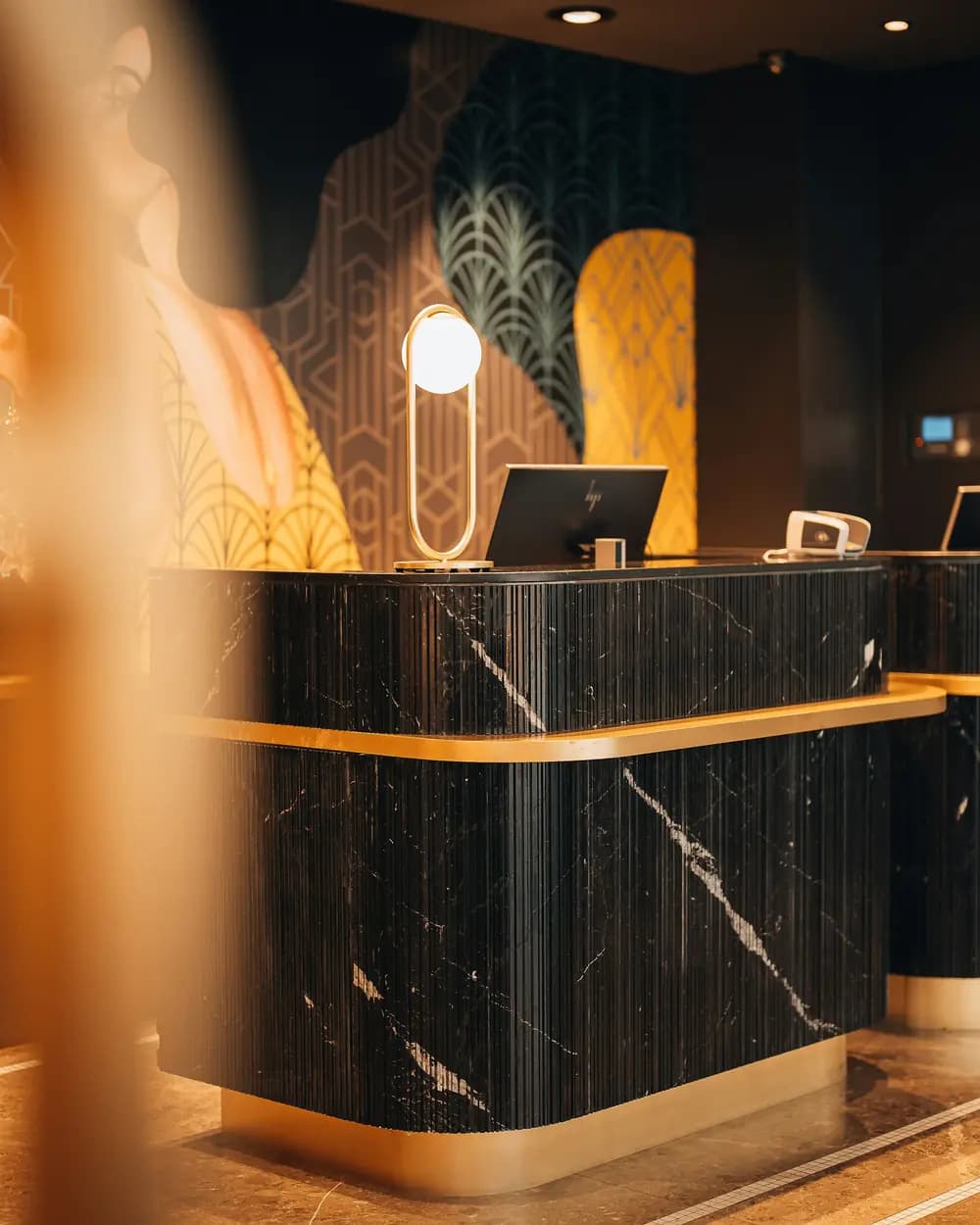 A hotel reception desk lit in the evening